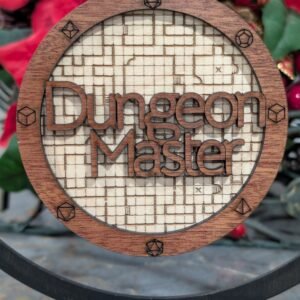 A wood laser engraved ornament, 4 in round with 2 layers. The background layer is an image of a dungeon map in a light brown. The top layer is a small border with engraved polyhedral dice, with the words Dungeon Master cut out of the middle sitting above the background layer.
