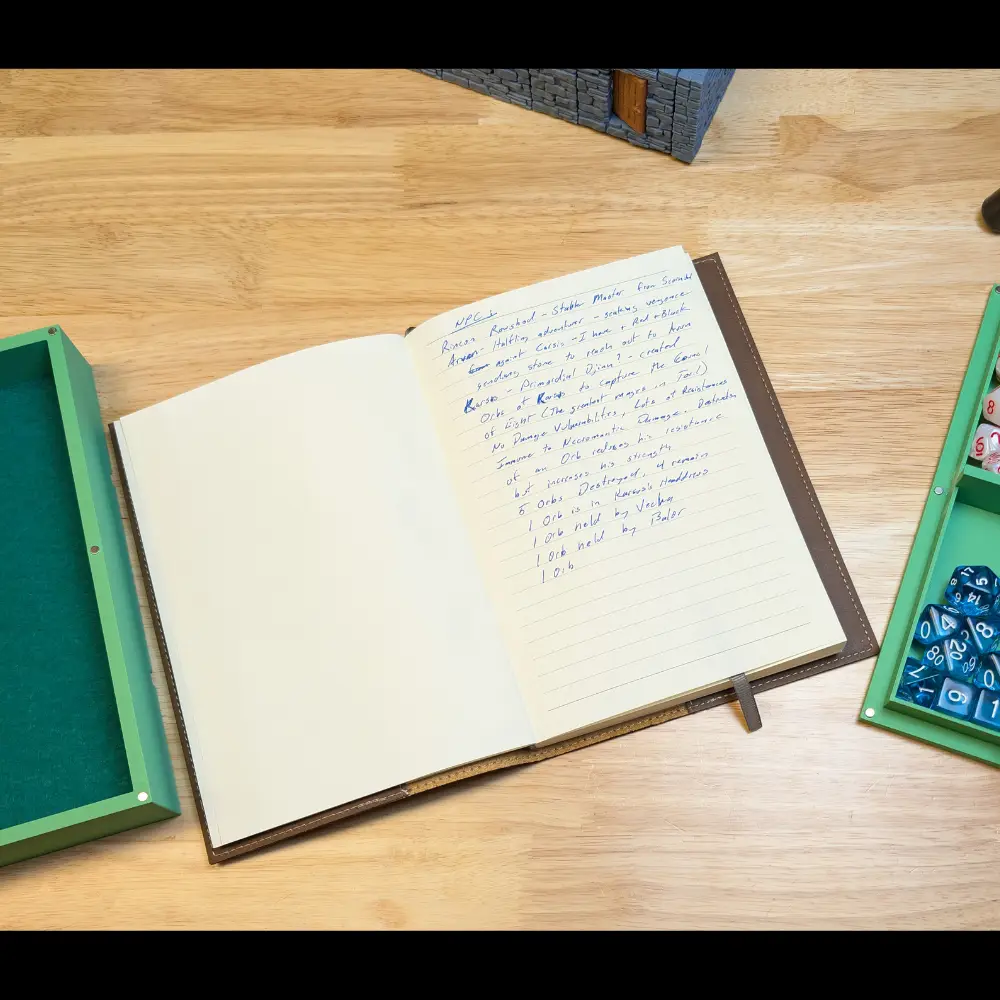 Open journal with writing on table with dice and terrain.